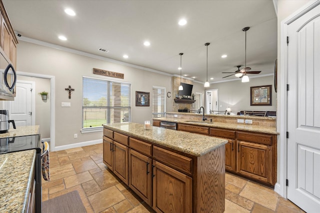 kitchen featuring a center island, brown cabinets, recessed lighting, stone tile flooring, and a sink