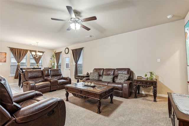 living room with ceiling fan with notable chandelier and light colored carpet