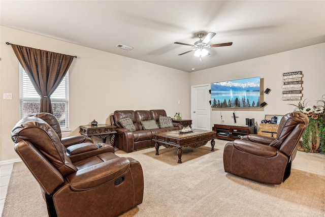 carpeted living room with ceiling fan