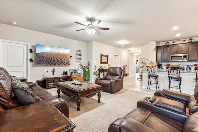 carpeted living room featuring ceiling fan