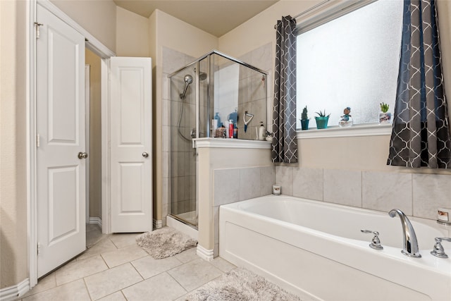 bathroom with independent shower and bath and tile patterned flooring