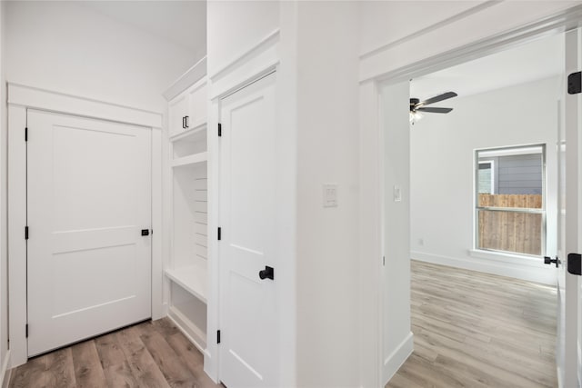 corridor with light hardwood / wood-style floors