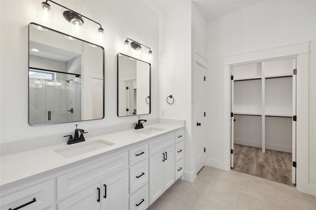 bathroom featuring vanity, an enclosed shower, and tile patterned floors