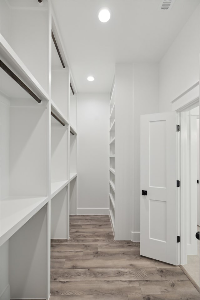 spacious closet featuring light wood-type flooring