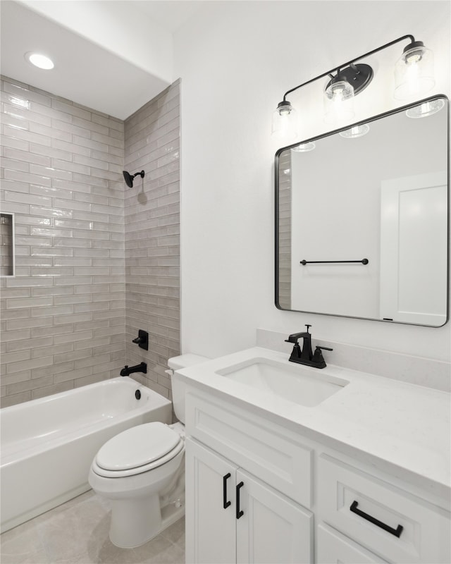 full bathroom with tiled shower / bath combo, vanity, toilet, and tile patterned floors