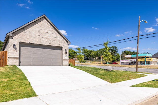 view of front of home featuring a front yard and a garage