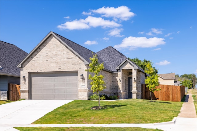 view of front of property featuring a garage and a front yard