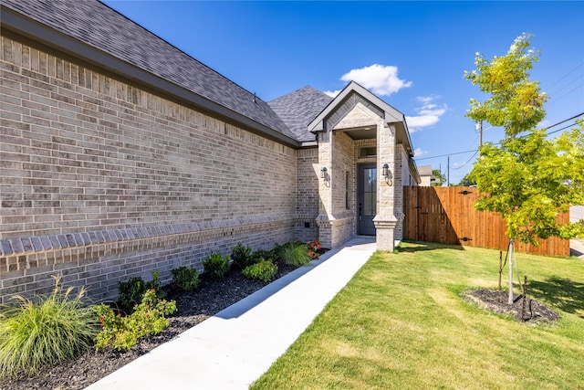 doorway to property with a lawn