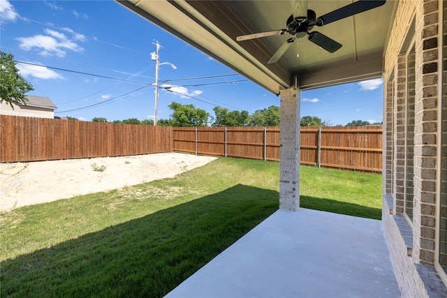 view of yard with ceiling fan and a patio area