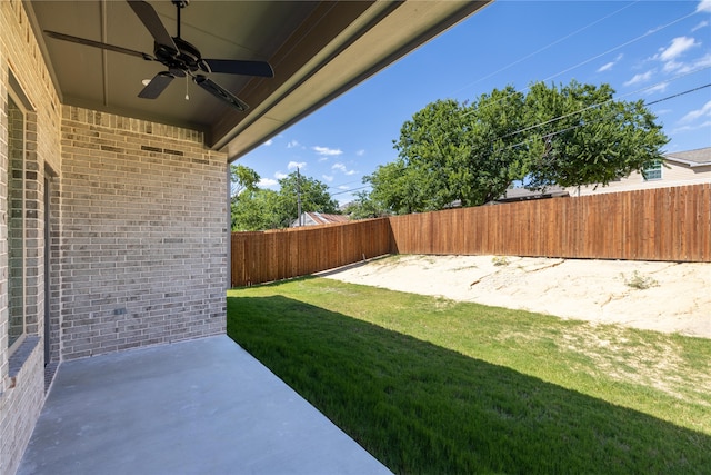 view of yard featuring ceiling fan and a patio area