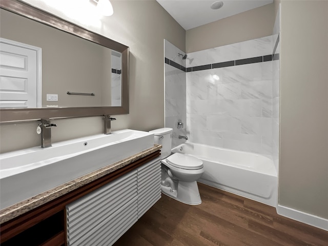 full bathroom with tiled shower / bath, vanity, toilet, and wood-type flooring