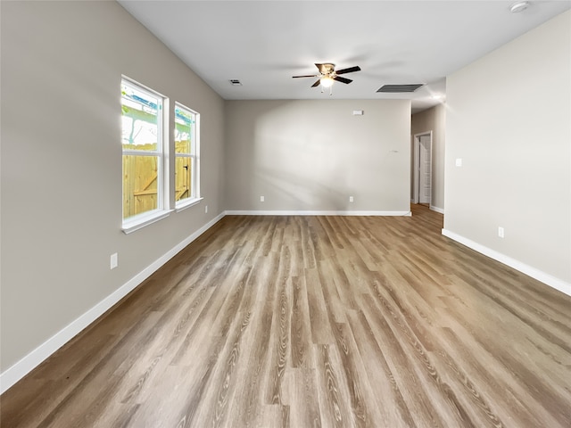 spare room featuring light hardwood / wood-style flooring and ceiling fan