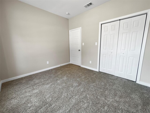 unfurnished bedroom with a closet and carpet flooring