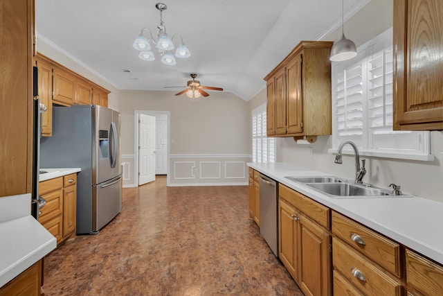 kitchen featuring vaulted ceiling, ceiling fan with notable chandelier, pendant lighting, stainless steel appliances, and sink