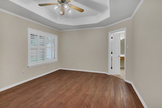 unfurnished room with crown molding, a textured ceiling, wood-type flooring, ceiling fan, and a tray ceiling