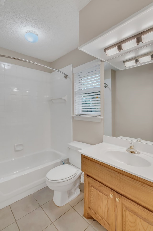 full bathroom featuring toilet, tile patterned flooring, vanity, a textured ceiling, and washtub / shower combination