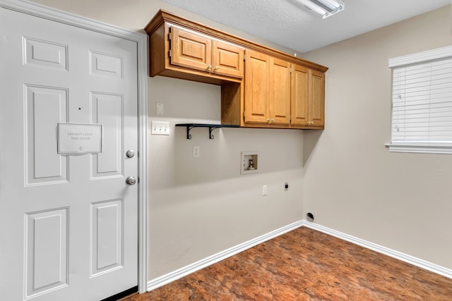 laundry area featuring hookup for a washing machine, cabinets, electric dryer hookup, and a textured ceiling