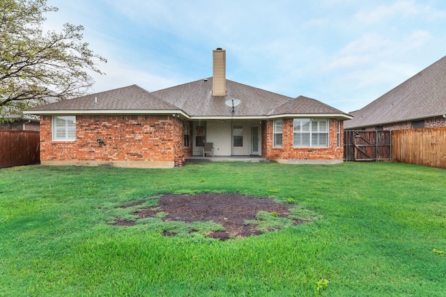 back of property featuring a lawn and a patio