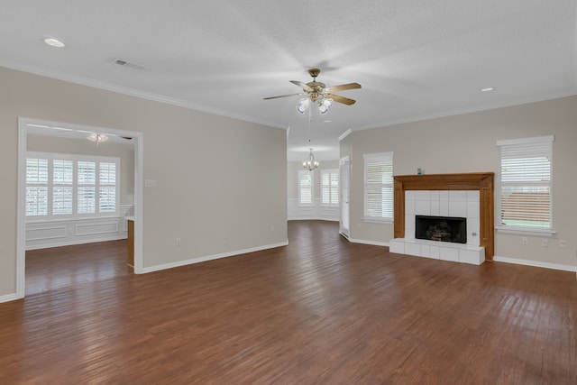 unfurnished living room with a tiled fireplace, dark hardwood / wood-style flooring, a healthy amount of sunlight, and ceiling fan