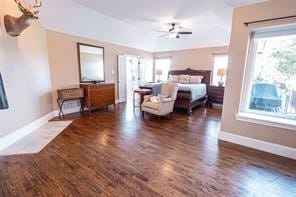 bedroom with ceiling fan and dark hardwood / wood-style floors