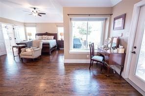 bedroom featuring baseboards and dark wood-style flooring