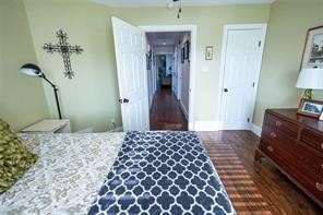 bedroom with dark hardwood / wood-style flooring