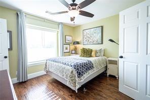 bedroom featuring baseboards, dark wood-style flooring, and ceiling fan