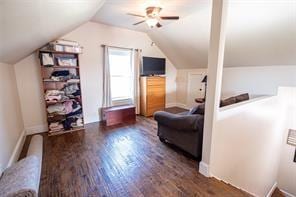 additional living space featuring ceiling fan, baseboards, wood finished floors, and vaulted ceiling