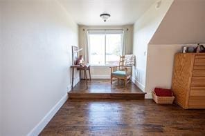 interior space featuring baseboards and wood finished floors