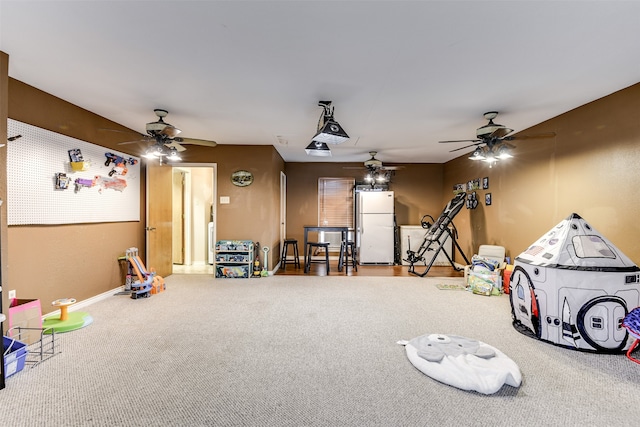 rec room with ceiling fan and carpet