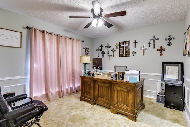 office area featuring ceiling fan, light colored carpet, and a textured ceiling