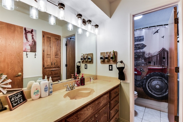 bathroom featuring vanity, toilet, and tile patterned floors