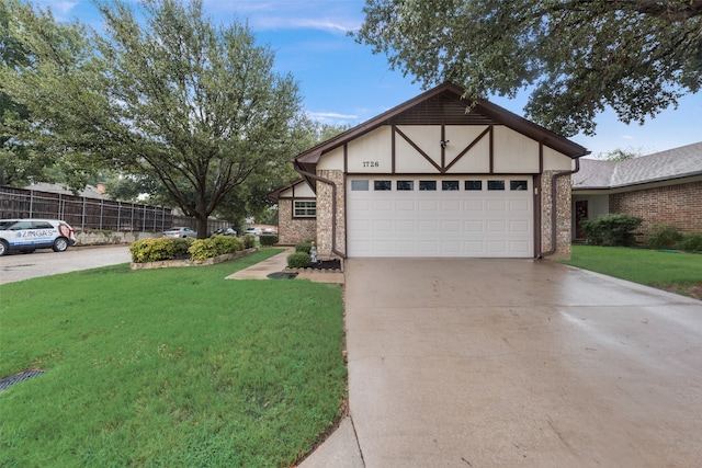 view of front of property with a front lawn and a garage