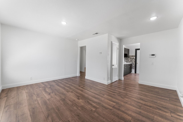 kitchen featuring a textured ceiling, dark hardwood / wood-style floors, sink, and backsplash