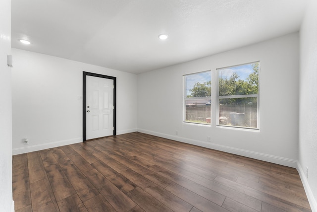 empty room featuring dark hardwood / wood-style flooring