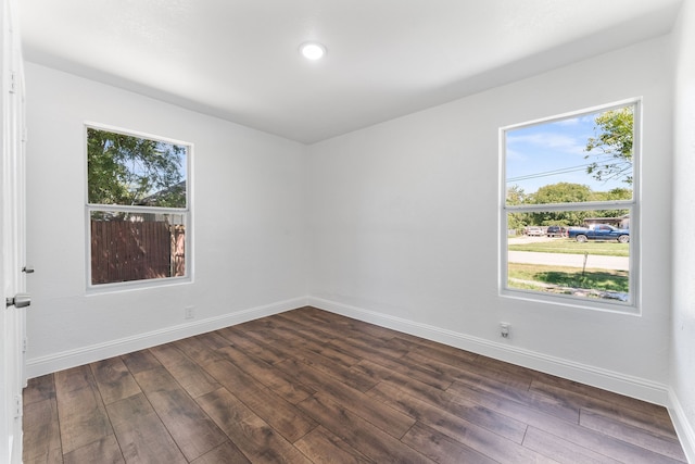 empty room with dark hardwood / wood-style flooring