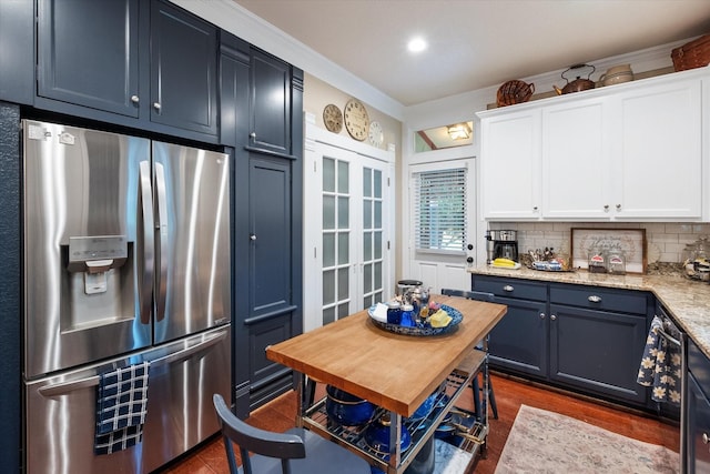 kitchen with white cabinets, stainless steel refrigerator with ice dispenser, decorative backsplash, and blue cabinets