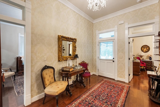 foyer entrance featuring dark hardwood / wood-style flooring, an inviting chandelier, and crown molding