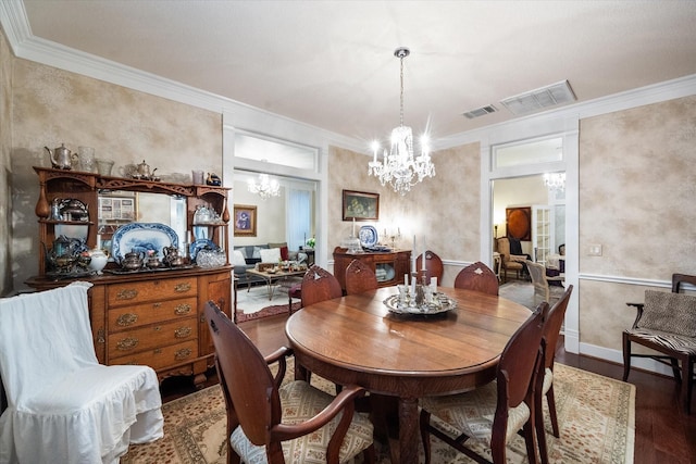 dining area featuring wood-type flooring, crown molding, and a notable chandelier