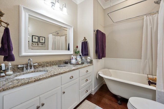 full bathroom with hardwood / wood-style floors, vanity, crown molding, toilet, and shower with separate bathtub