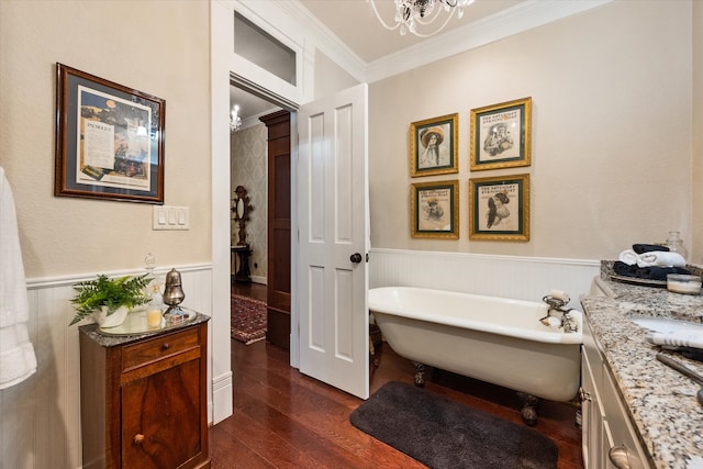 bathroom featuring a bath, crown molding, a chandelier, vanity, and hardwood / wood-style flooring