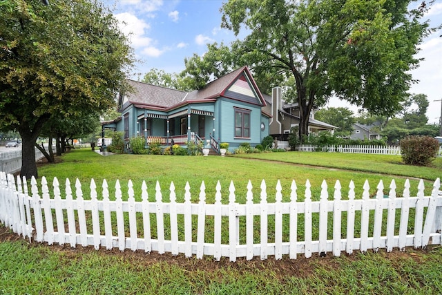 view of front of house with a porch and a front lawn