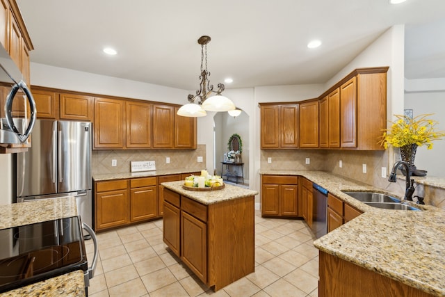 kitchen featuring light stone countertops, a center island, stainless steel appliances, sink, and hanging light fixtures