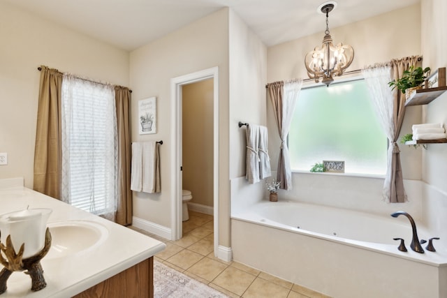 bathroom featuring vanity, toilet, a washtub, and a healthy amount of sunlight