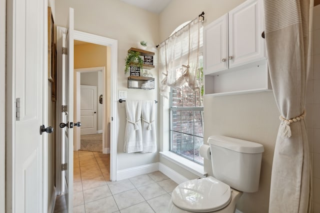 bathroom with toilet and tile patterned flooring