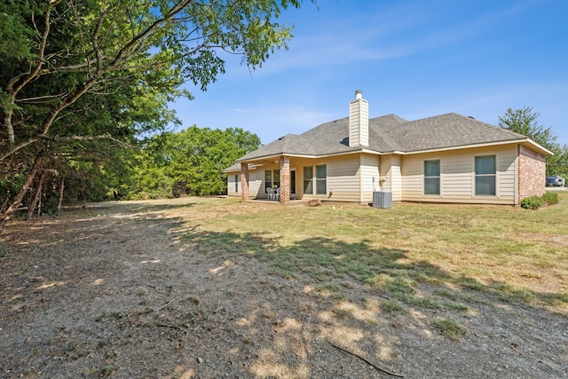 rear view of house with a lawn