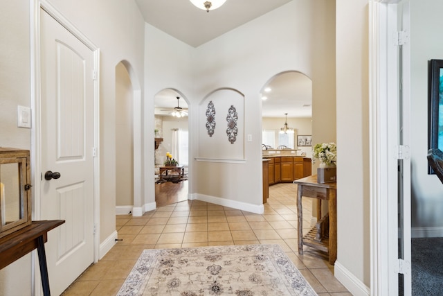 tiled foyer with ceiling fan