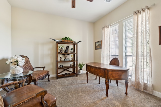 carpeted office featuring ceiling fan