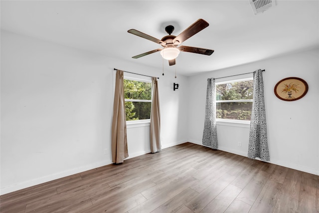 empty room featuring hardwood / wood-style flooring and ceiling fan