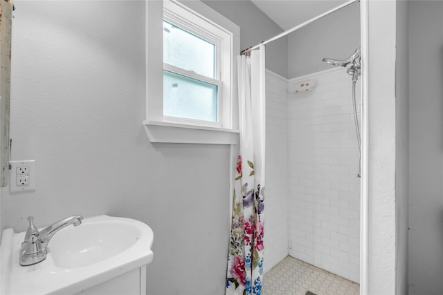 bathroom featuring curtained shower and sink